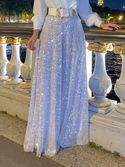 Elegantna bluza z dolgimi rokavi in V-izrezom ter široke hlače z bleščicami