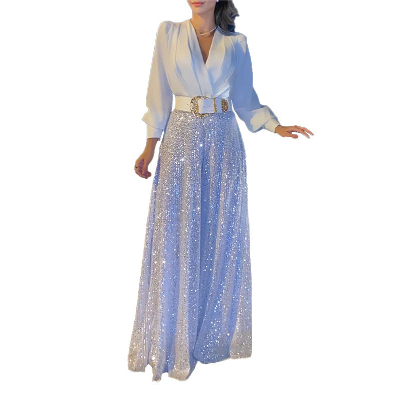 Elegantna bluza z dolgimi rokavi in V-izrezom ter široke hlače z bleščicami